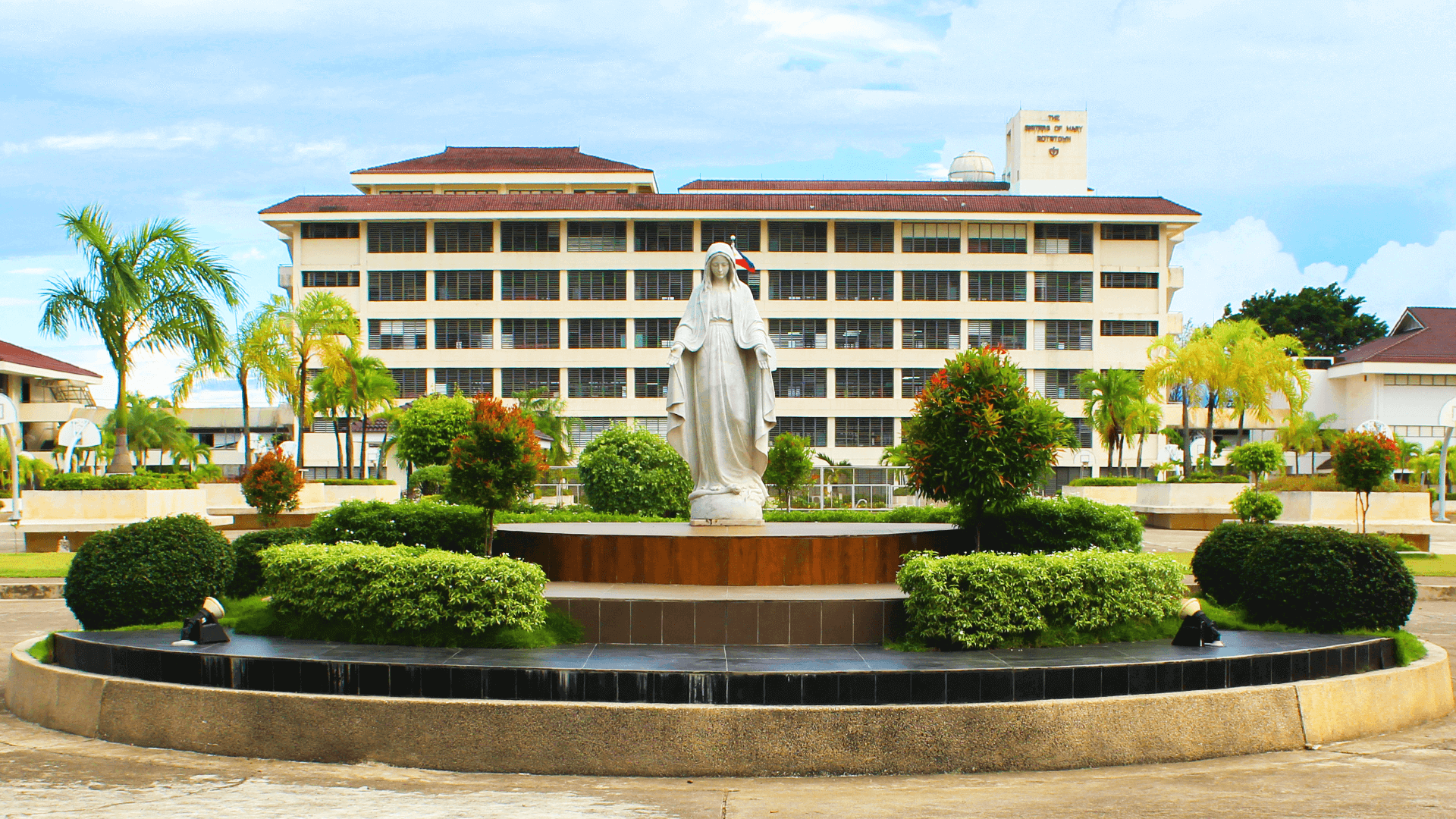 School building and gardens at a Sisters of Mary Boystown campus